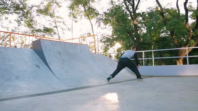 Young man doing parkour tricks in extreme sports park