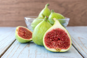 Fresh ripe figs in a bowl close up on a wooden background