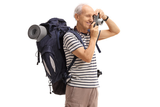 Elderly hiker taking a picture with a camera