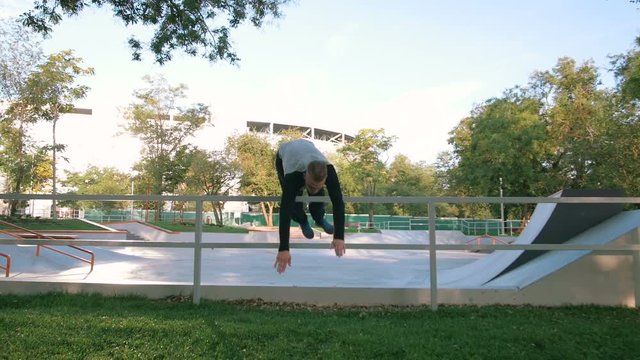 Young man doing parkour tricks in extreme sports park