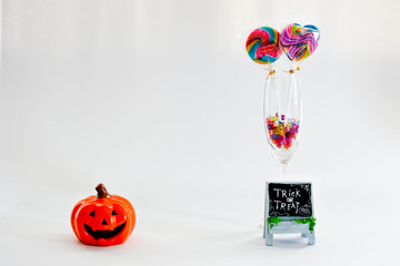 Jack'o lantern, colorful lollipop in glass and cystal beads, thick or treat on white background. Lovely props for halloween festival.