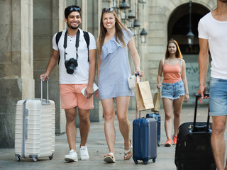 Fototapeta na wymiar Smiling traveling man and woman walking on vacations