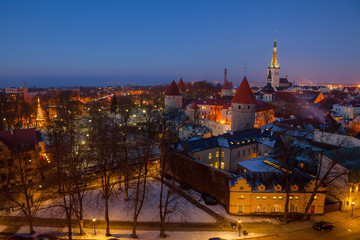 Fototapeta na wymiar Exciting winter view of night old town of Tallinn. Aerial over roofs and towers.