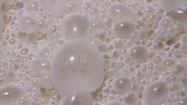 Fermentation process of yeast at the factory for baking bread macro. Ripe sourdough yeast ferments in a vat. Fermentation of yeast ferment close-up at the factory. Bread Factory.