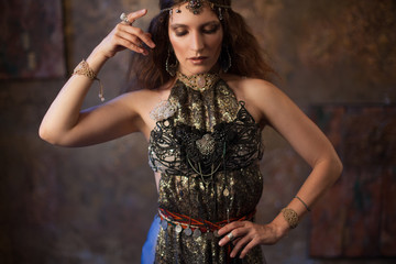 Tribal dancer, beautiful woman in the ethnic style on a textured background