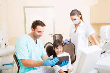 Dentist with a little girl and a Tablet PC.