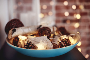 A bowl full of christmas wooden decorations