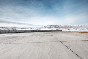 empty floor with white snow mountain in blue sky