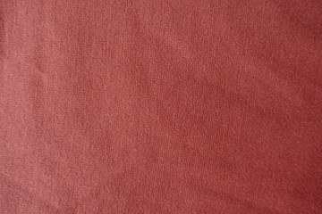 Coral colored simple jersey fabric from above