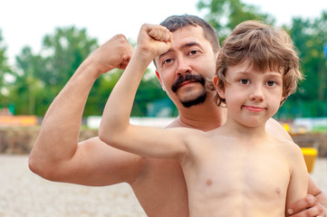 Father and son demonstrate their strength