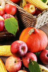 Thanksgiving - pumpkin, apples, and maize on wooden background