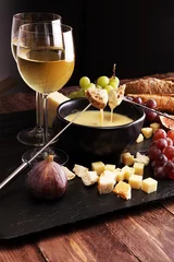 Fototapeten Gourmet Swiss fondue dinner on a winter evening with assorted ch © beats_