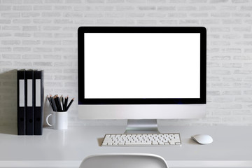 Work space Mock up white tabletop with modern computer ,files folder and pencils on white wood deskwith white brick wall at home or studio office. copy space for products display montage.