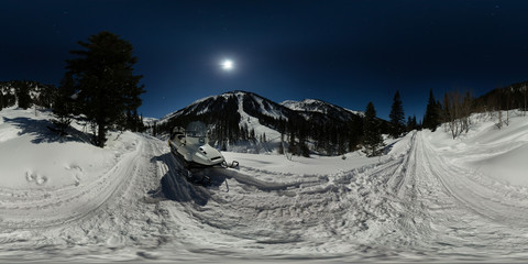 Snowmobile on a moonlit night on the road in the mountains. Spherical 360 180 panorama