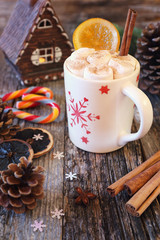 Winter drink: cup of hot chocolate with marshmallow and two french sucking candy Arc-en-ciel