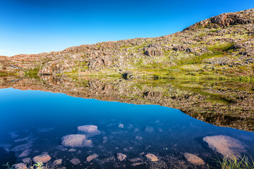 Fototapeta premium beautiful mountain lake, mirror water surface, blue sky
