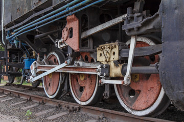 Fototapeta na wymiar Fragment of a old rusty locomotive