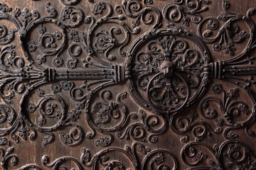 Old wooden door with a metallic pattern
