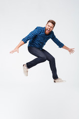 Full length portrait of a excited funny bearded man jumping