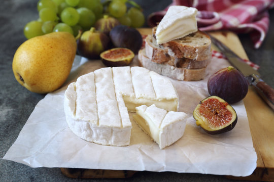 Camembert cheese, figs, fruits and bread