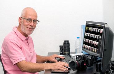 photographer with camera at office with computer