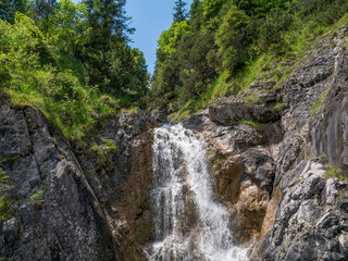 Fototapeta na wymiar The waterfall on mountains in Bavaria, Germany