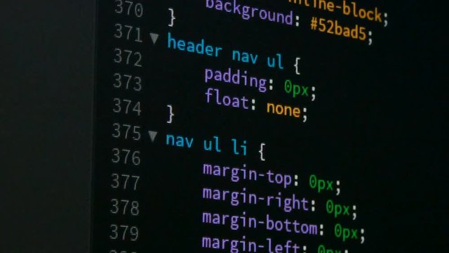 Programmer scrolling up and down for editing page of html css website code editor