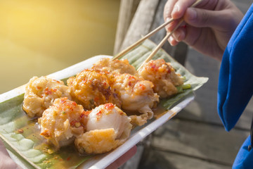 Holding mini Fried Mussels in Batter,Floating market at Ayutthaya