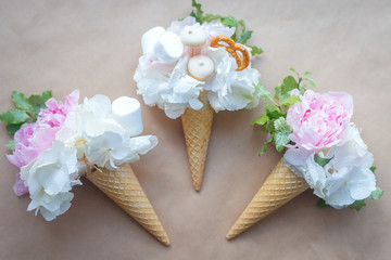 bouquets of peonies in a waffle cone on craft paper