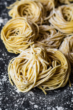 Fresh pasta on floured cement surface