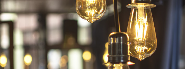 Old Style Glowing Light Bulbs Hanging in Bar - 171599312