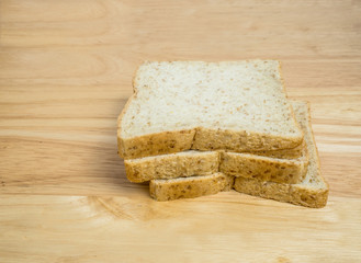 Three slice whole wheat bread on wooden table