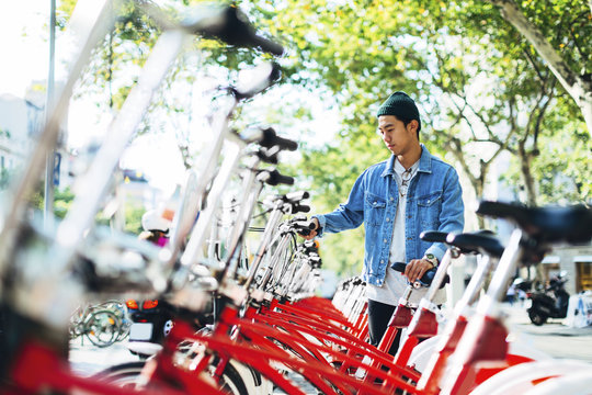 Man renting bicycle on street