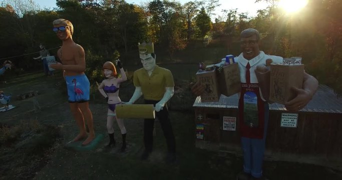 Aerial views of an eccentric&rsquo;s collection of giant American roadside attractions and oddities like Muffler Man, Brian the Beach Boy, giant apple, crab, the Simpsons riding a train around Santa Claus p