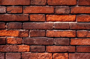 Old grunge brick wall background red color, close up. Vintage textured brick backdrop.