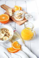 healthy breakfast bowl of yogurt with granola and banana