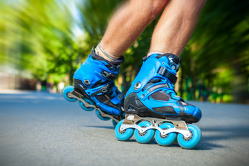 Closeup of Inline roller skater on a slalom course.