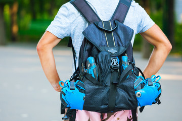Young male roller skater with roller backpack - shoot from behind. © Dmytro Panchenko