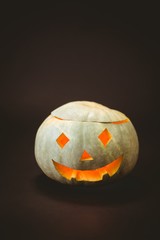 Illuminated jack o lantern over black background