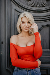 Close-up portrait of cute smiling woman on a background of gray vintage door urban style