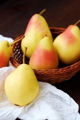 Juicy ripe yellow pears in a wooden table 