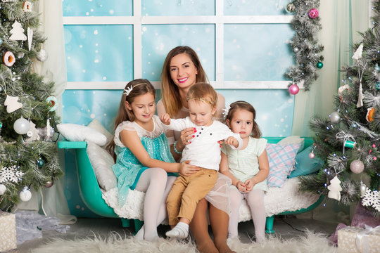 Children and a young mother in a Christmas decorations