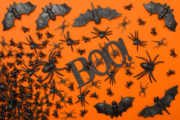 Halloween background, black spiders on the orange background