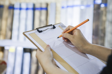 Woman checking quality of timber