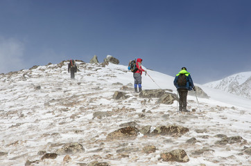 hiking in winter mountains. People traveling