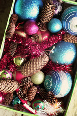 Decorative christmas balls and fir-tree cones close up.