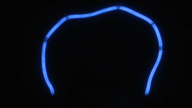 Close-up of a blue tungsten filament. Smooth increase and decrease in power.