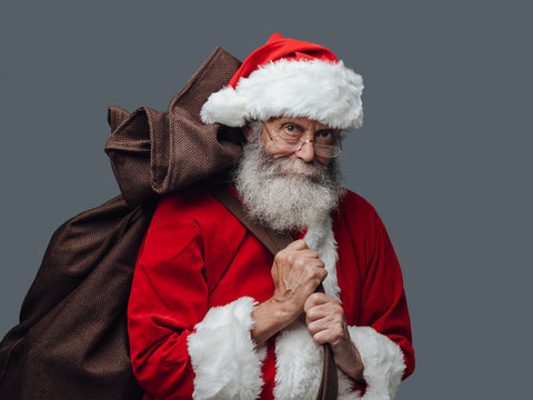 Santa Claus carrying Christmas gifts
