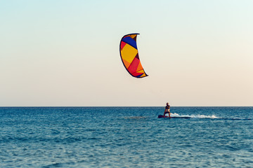 Kitesurfing at sunset at sea