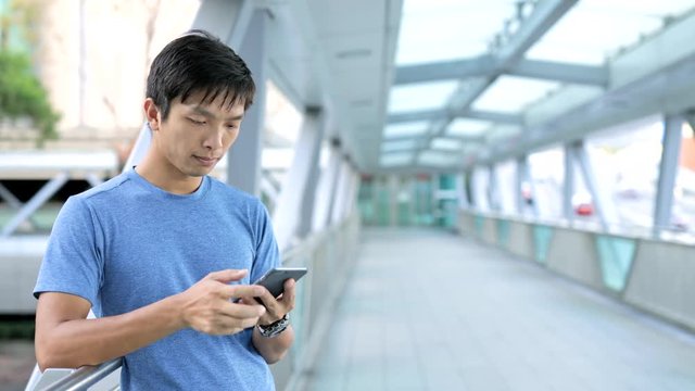 Asian man use of smart phone in city